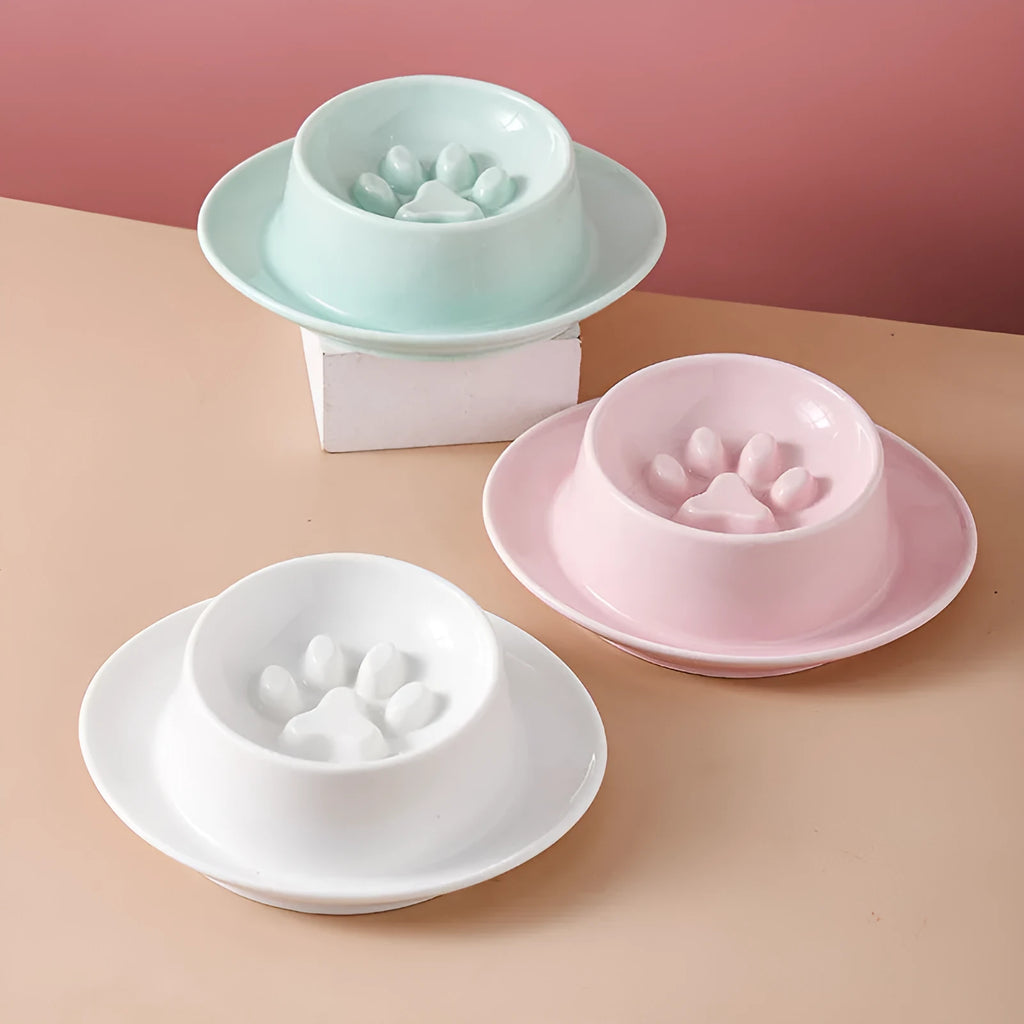 Green ceramic slow feeder pet bowl with raised centre and non-slip base.