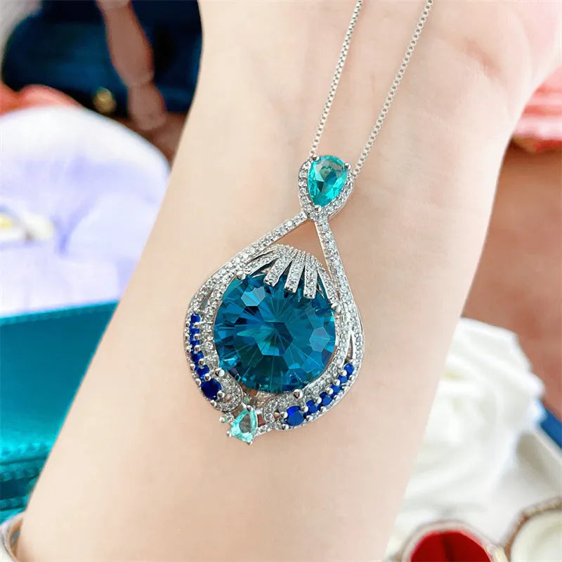 Blue geometric pendant necklace with fireworks cut crystal gemstone and water wave chain