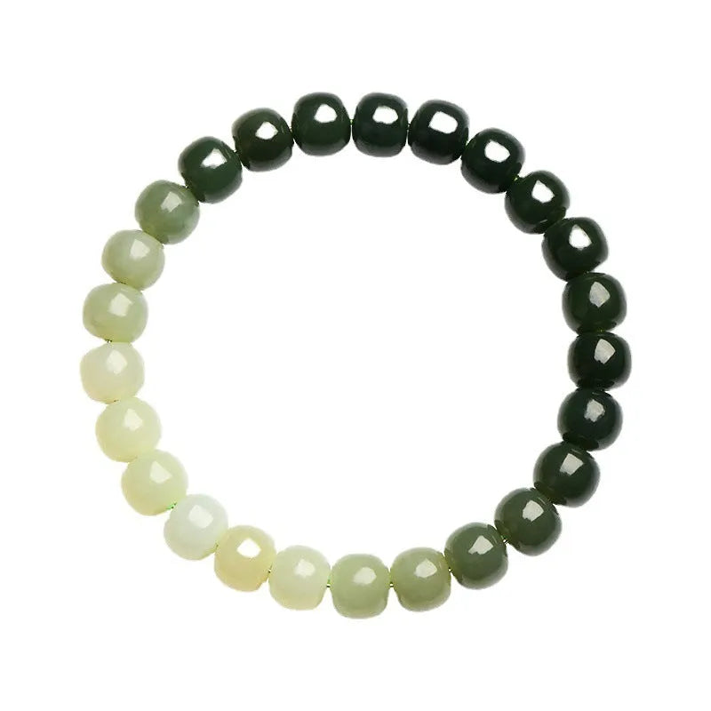 Natural Hetian jade bracelet with sunny water gradient colour on a wrist, showing oval beads.