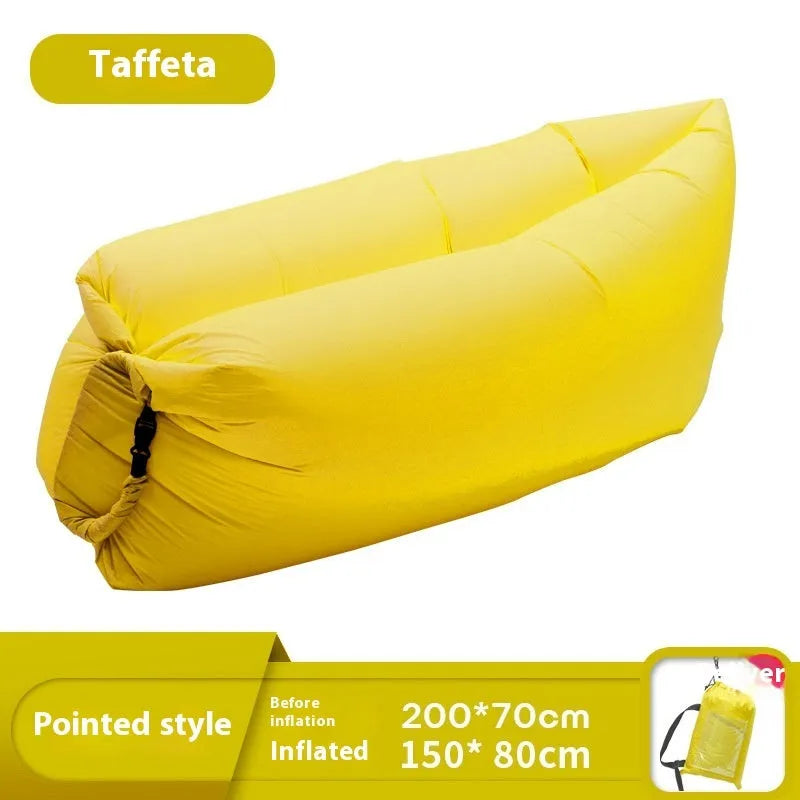 Yellow smiling face tip inflatable portable outdoor sofa seat on grass