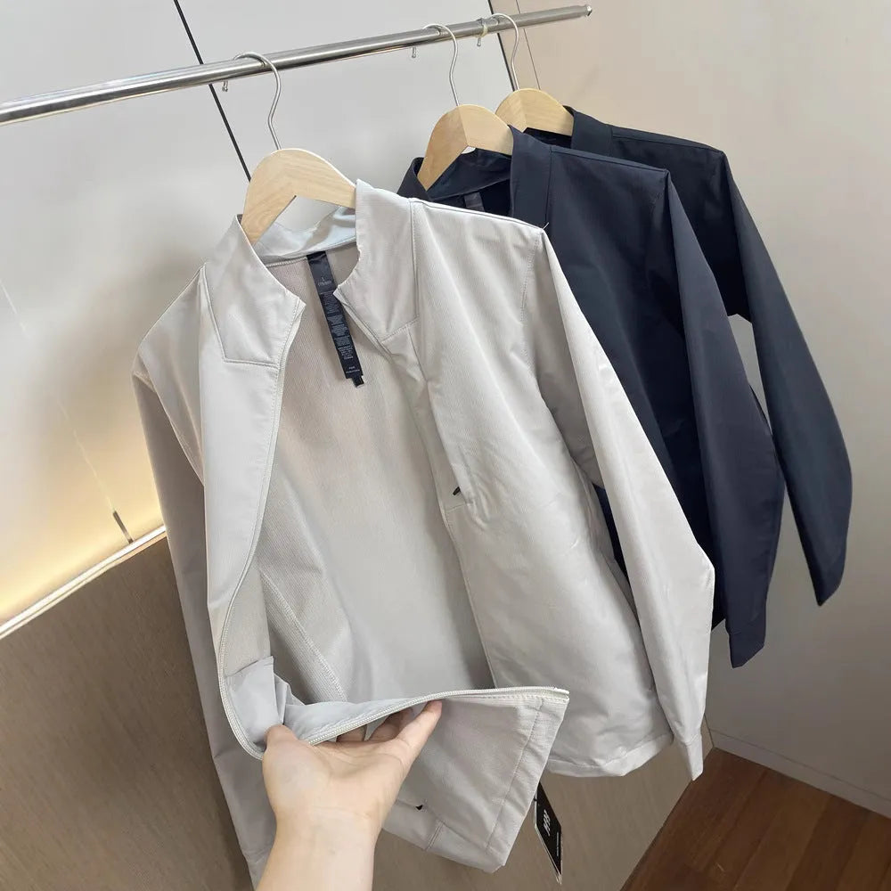 Man wearing a milky white stand collar casual jacket with long sleeves and a straight hem.