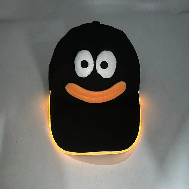 Black Halloween baseball cap with LED pumpkin smile face and yellow lights illuminated.