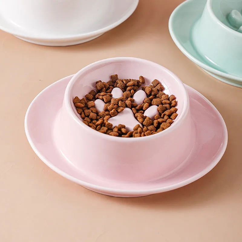Green ceramic slow feeder pet bowl with raised centre and non-slip base.