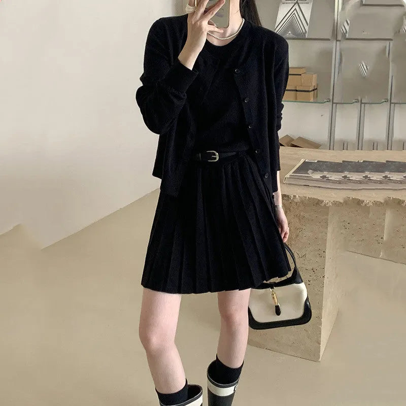 Women's grey art retro two-piece set with pleated vest skirt, adjustable belt, and long-sleeved knitted cardigan.