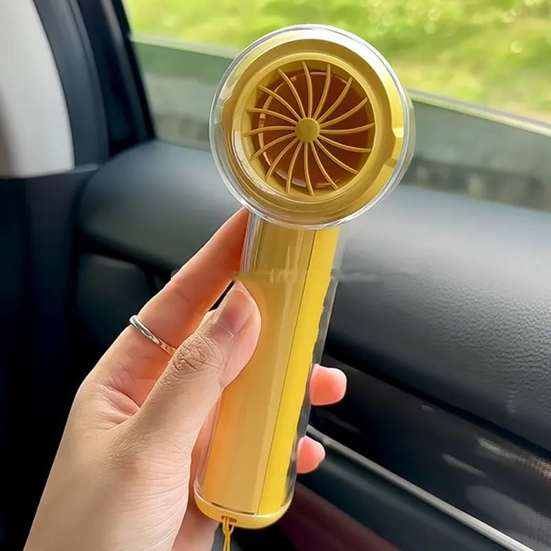 Yellow handheld fan with ice compress function showing compact size and USB port.