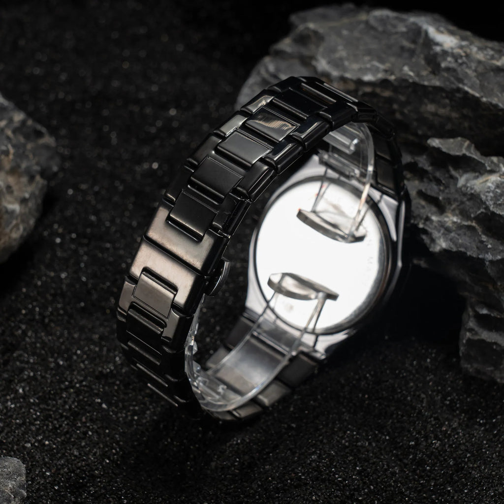 Business casual men's quartz watch with a steel belt on a wrist, showing dial colour options of black, black with silver scale, or silver with black accents.