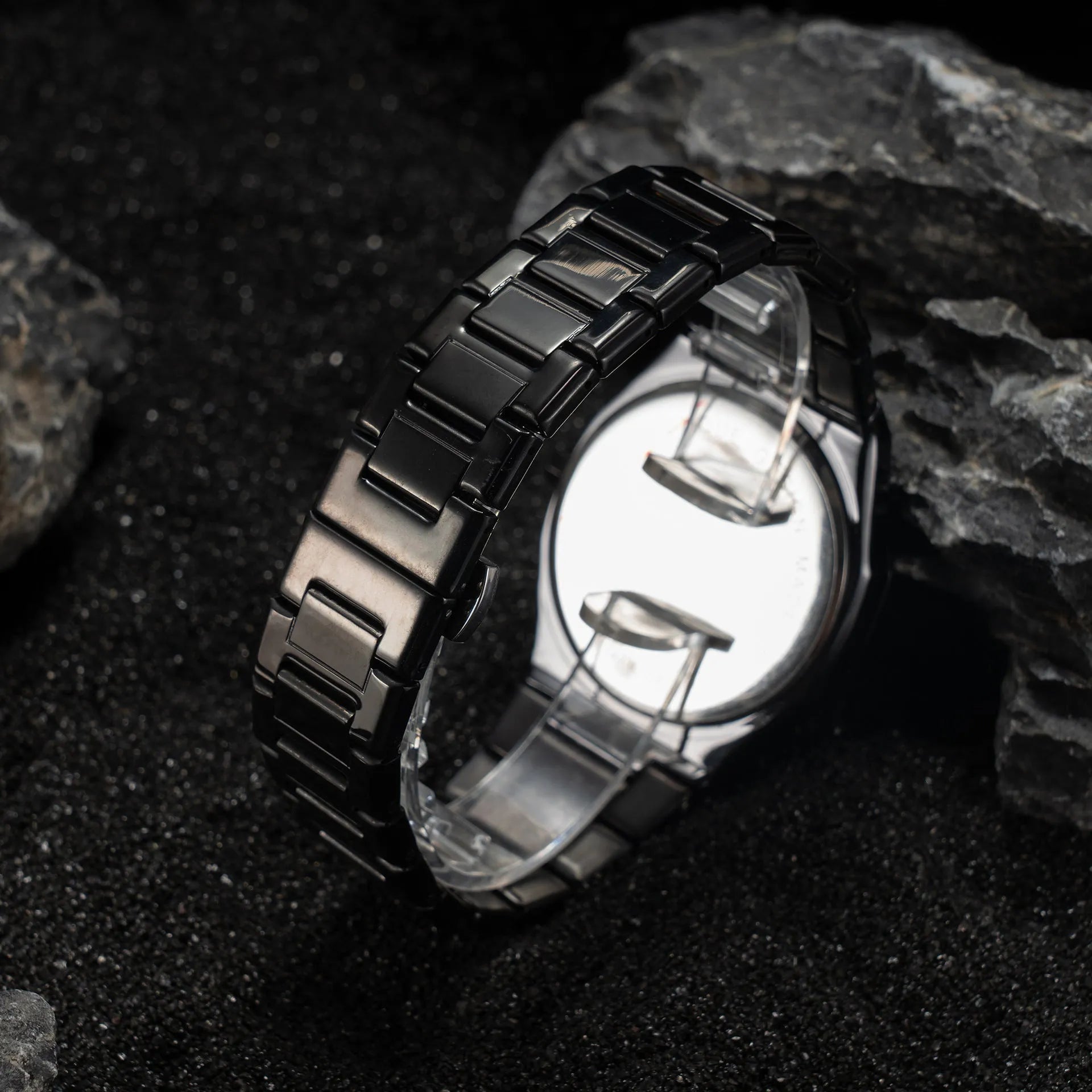 Business casual men's quartz watch with a steel belt on a wrist, showing dial colour options of black, black with silver scale, or silver with black accents.