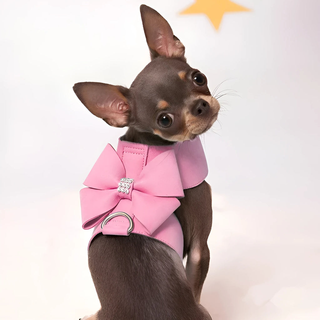 A cute pink microfiber puppy chest strap with a bowknot, showing the adjustable design.