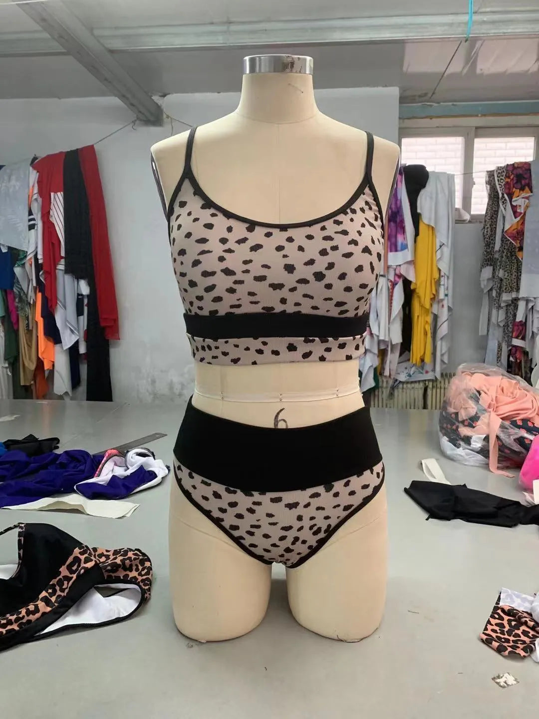 Women's white and leopard print high waist split bikini swimsuit laid flat.