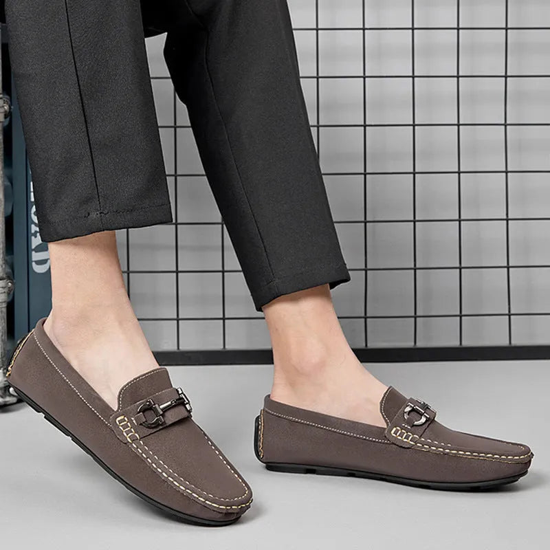 Men's beige leather casual loafers with a round toe and rubber sole.