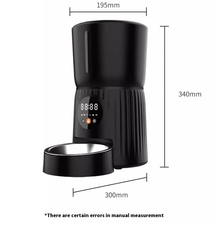 Black automatic pet feeder with digital display and food bowl on a kitchen counter.