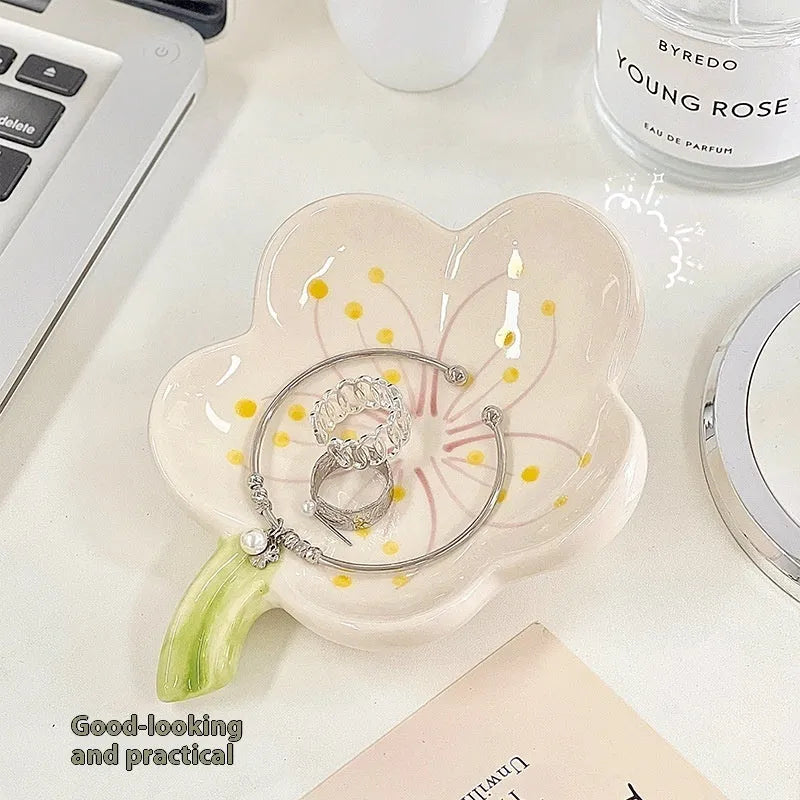 Yellow and white porcelain shell-shaped tray with integrated small LED night light on a wooden surface.