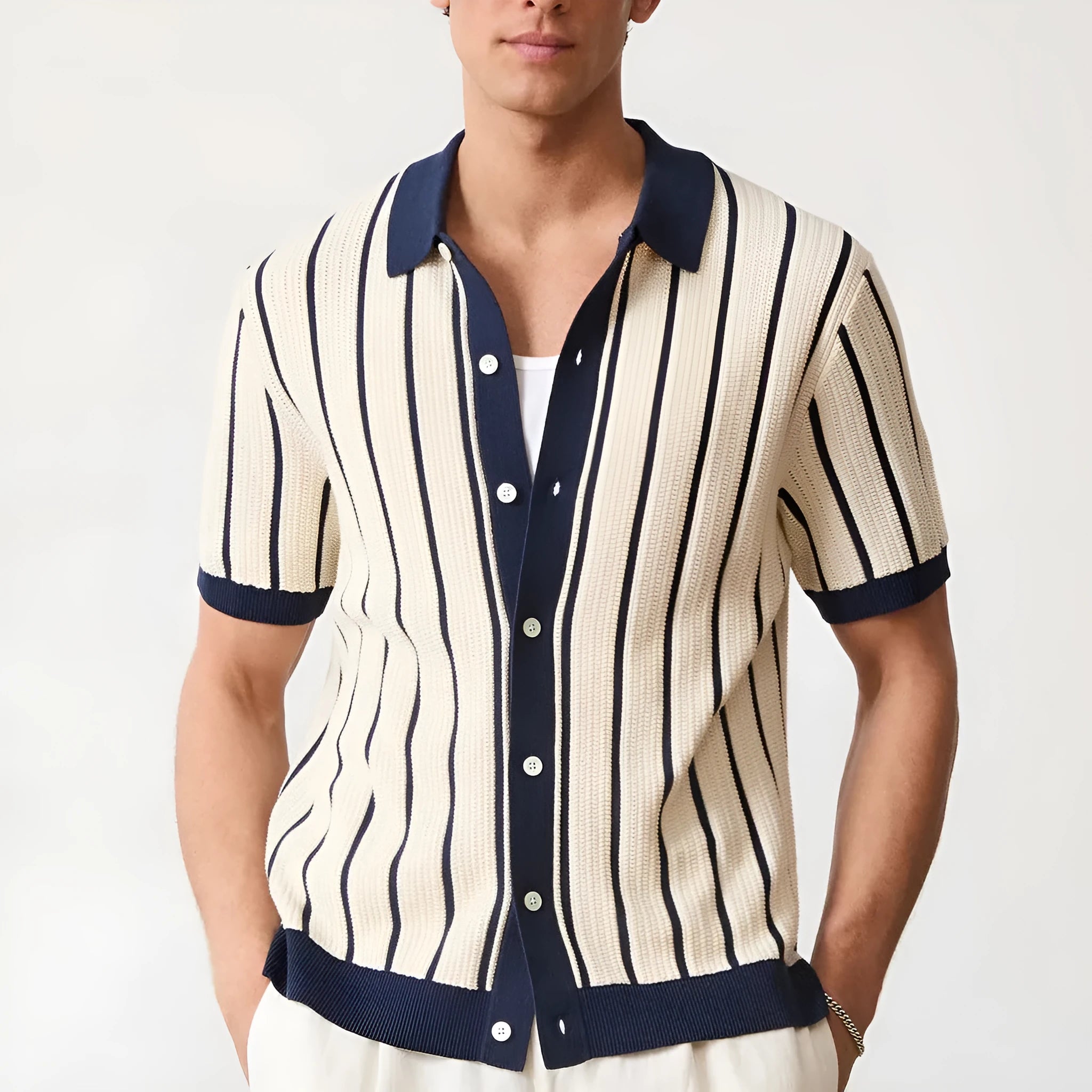 Men's white asymmetric lapel knit top with short sleeves on a model.