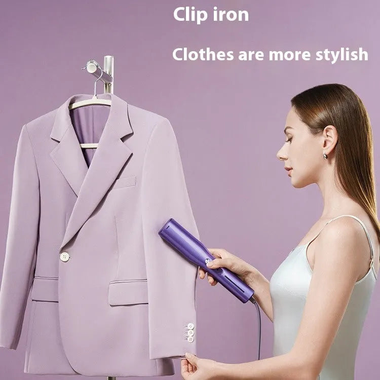 Handheld garment steamer with plastic housing showing steam control buttons and UK plug
