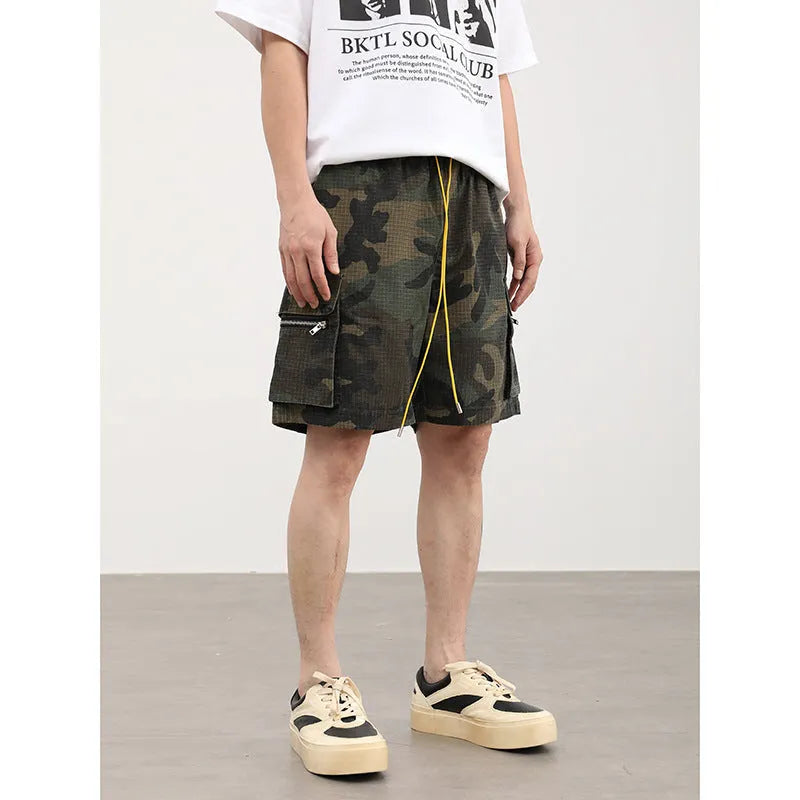 Men's camouflage pattern multi-pocket work shorts in a cropped length.