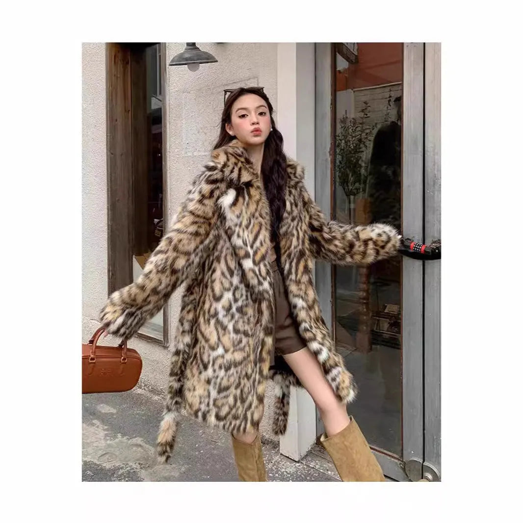 A person wearing a grey faux fur coat with a large fur collar and front pockets, in a street-fashion style.