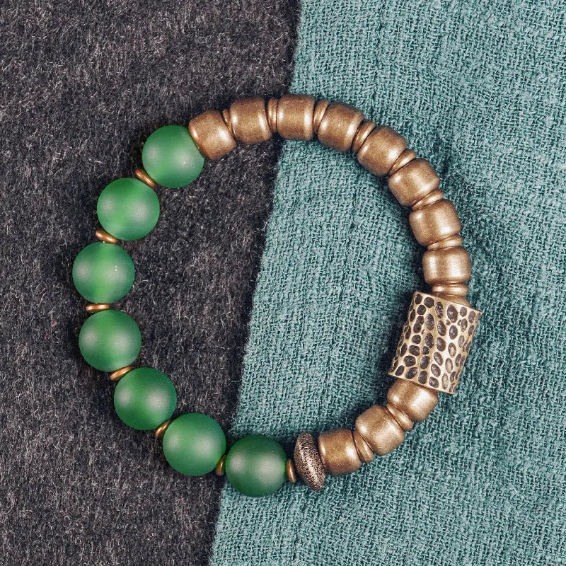 Retro ethnic style couples bracelet made from natural green agate beads on a wrist.