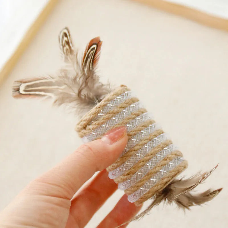 Beige cat toy with real feathers attached to hemp rope scratching surface and integrated claw roller