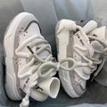 Women's grey chunky platform sneakers with thick rubber sole and lace-up front