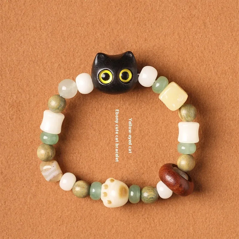 Hand-woven beaded bracelet with a cat's paw charm, jade, and wood beads in a cartoon style.