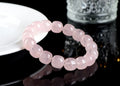 Pink crystal barrel bead bracelet with geometric design on a bamboo string.