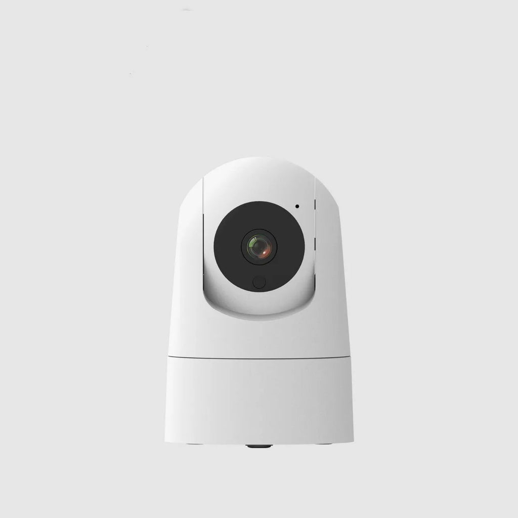 White indoor security camera with wide-angle lens on a shelf, showing companion app on a mobile phone.
