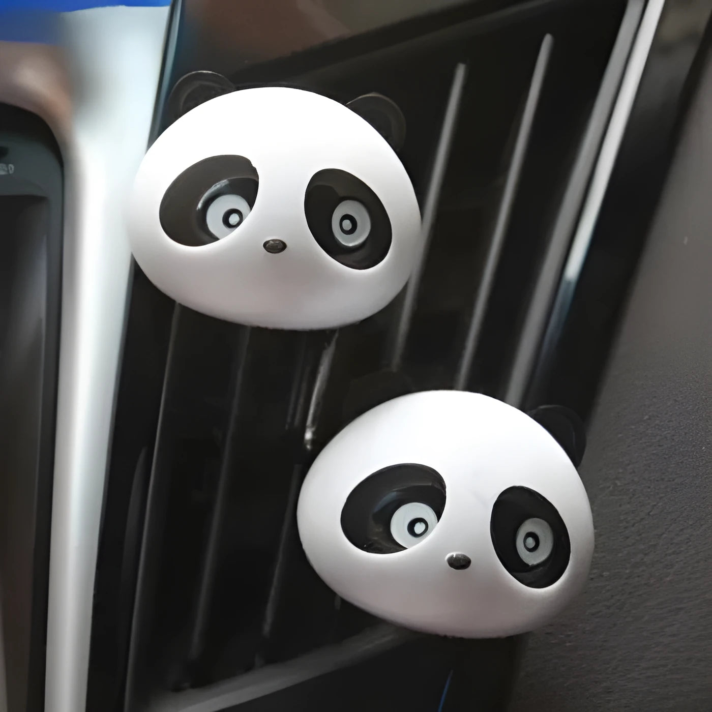 Pair of panda grain car vent perfume decorations in black and brown showing clip attachment