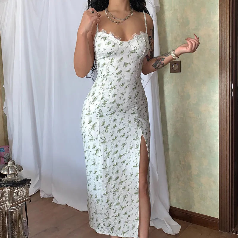 Women's blue lace flower print long suspender dress with a high leg slit on a model.