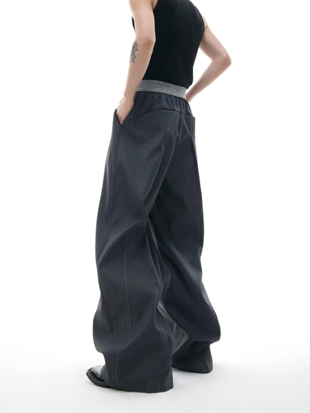 A pair of high-waisted straight-leg casual trousers in grey, showing the button-fly detail.