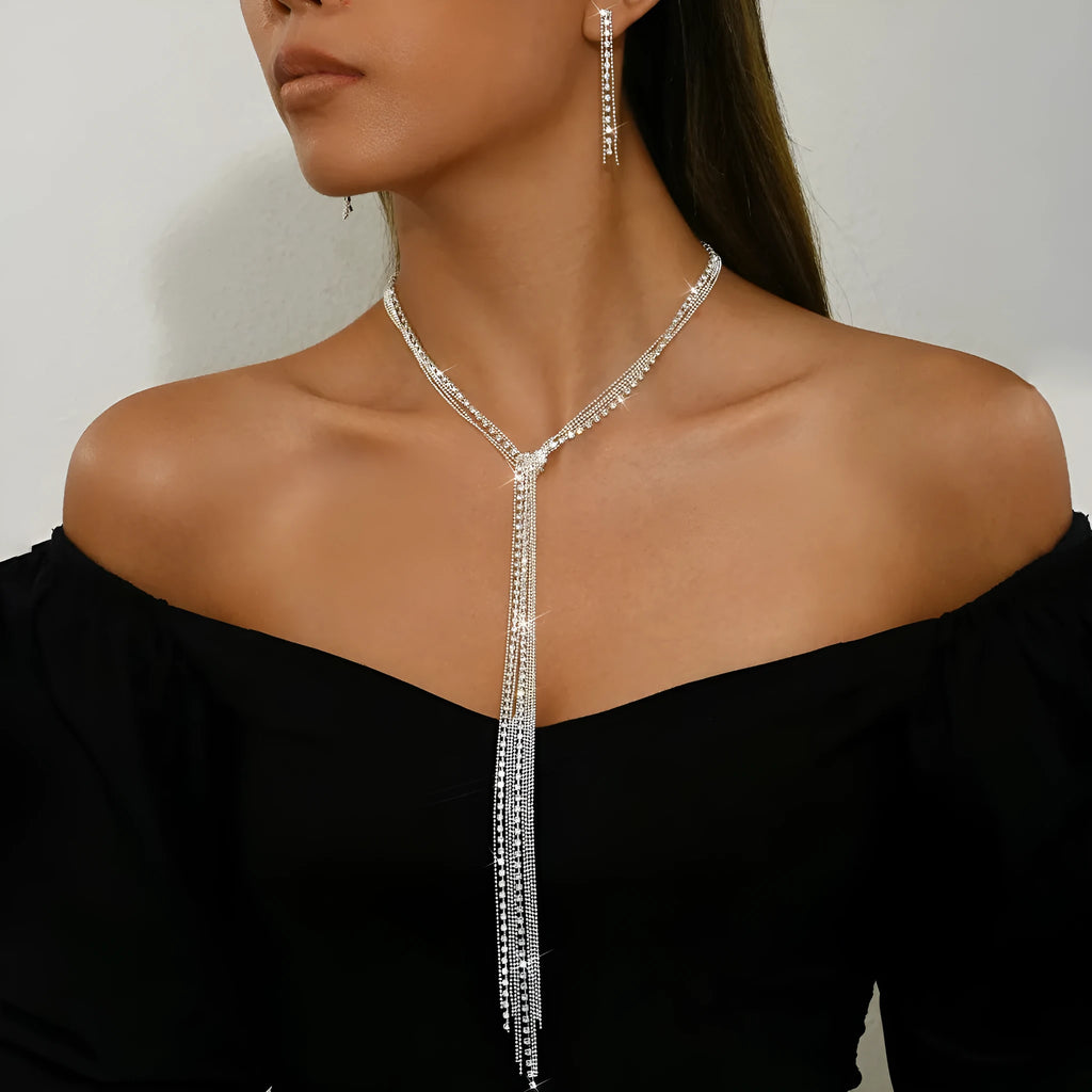 Silver curb chain necklace with rhinestone pendant and matching long earrings in a three-piece set for women
