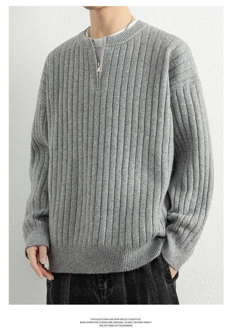 Men's grey half-zip loose knit sweater with textured fabric and long sleeves.
