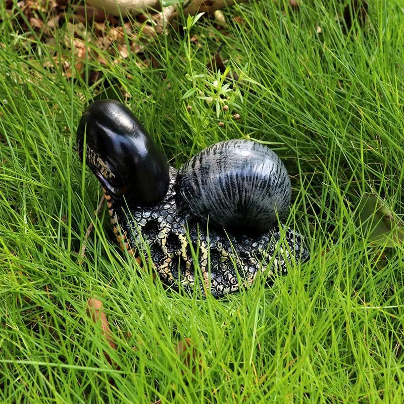 Resin garden snail sculpture with character design and coloured finish