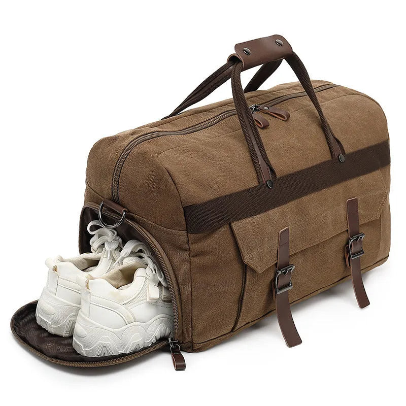 Canvas crossbody travel bag in black with sewing line detailing showing 36-55 litre capacity