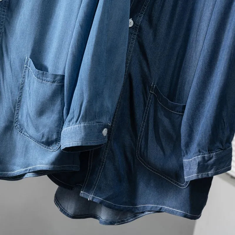 Men's dark blue three-quarter sleeve V-neck casual denim coat laid flat.