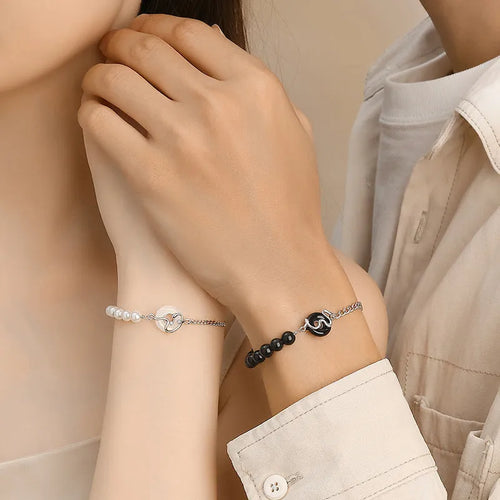 Close-up of a 925 sterling silver bracelet with a snake design, obsidian pearl, and a safe buckle clasp.