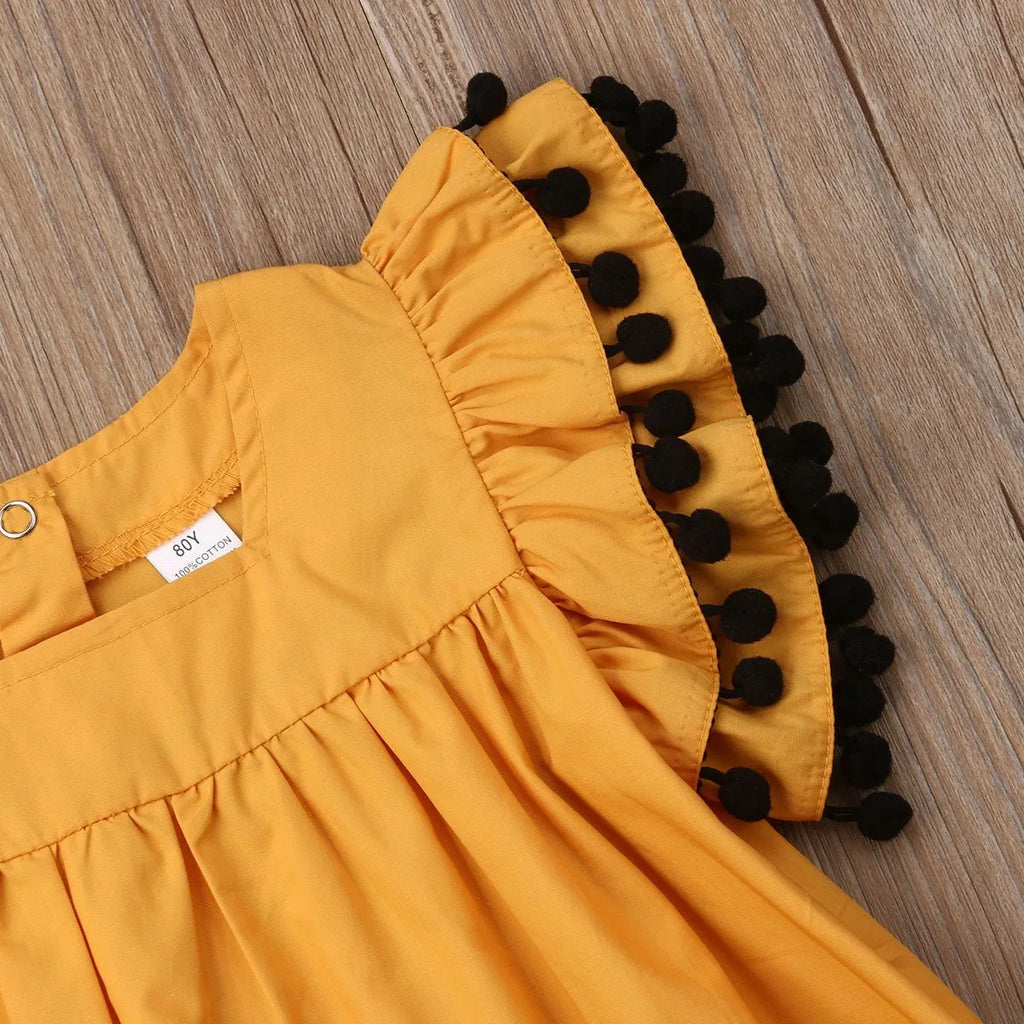 Orange sleeveless dress for toddler girl with shirring detail on front and elasticated back.