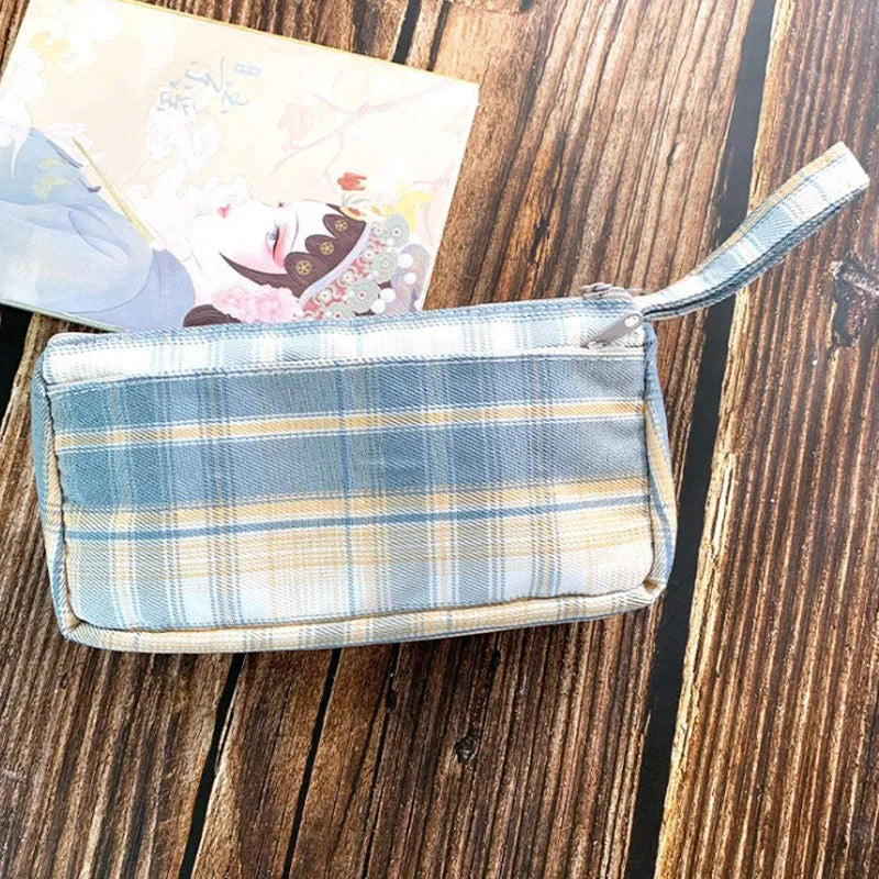 Square double-layer canvas stationery bag in a red stripe grid pattern.