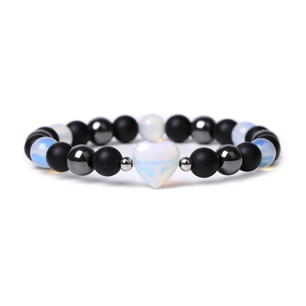 Hand-cut peach heart stone bracelet in geometric design with planetary elements
