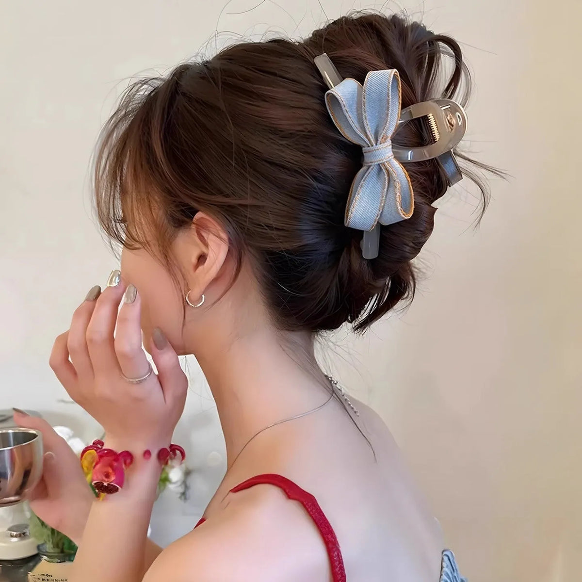 Denim blue bow hair barrette for women with metal clip, shown as a cloth bow hair accessory