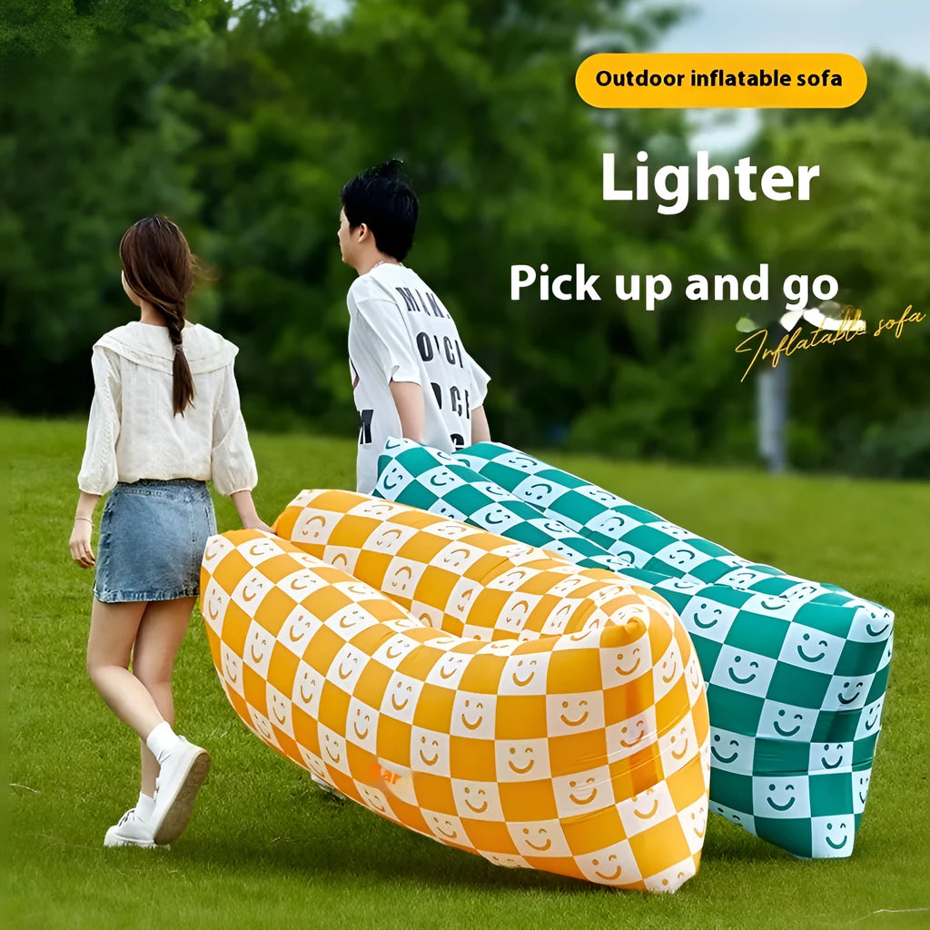 Yellow smiling face tip inflatable portable outdoor sofa seat on grass