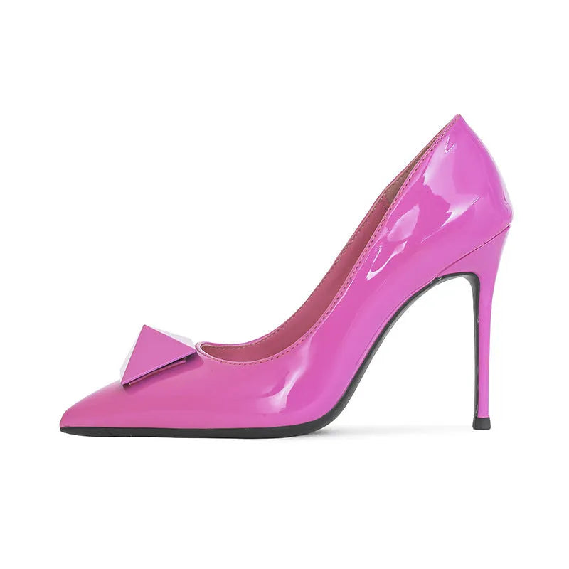 Pink women's pointed toe stiletto high heels with a rivet buckle on a glossy patent leather upper.
