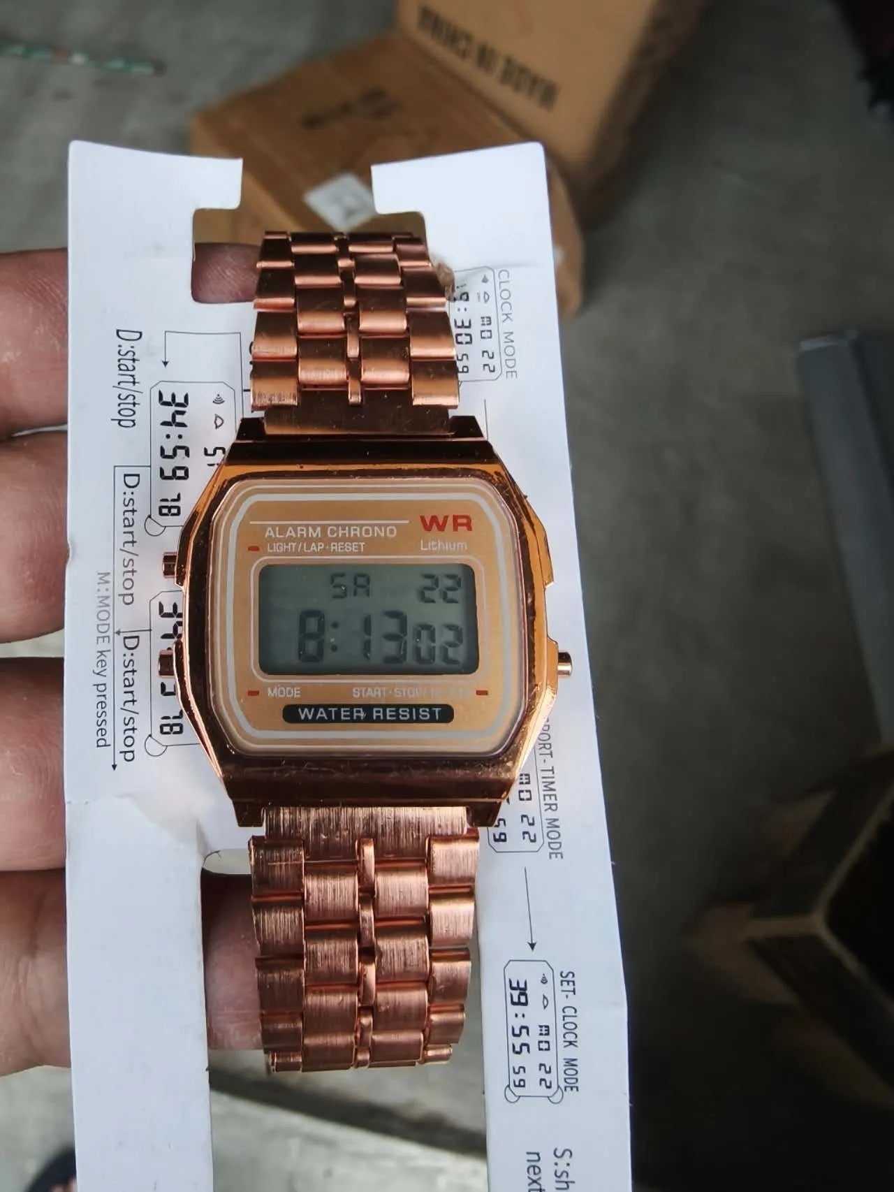 Rose gold analogue watch with round stainless steel case, luminous hands, and date display on a white background