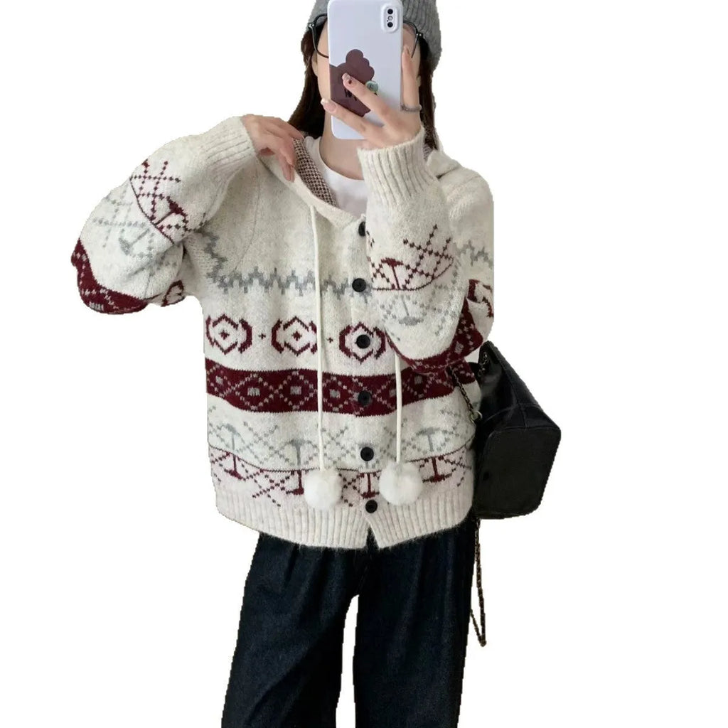Plus size woman wearing a loose, geometric patterned grey acrylic sweater coat.