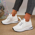 Women's black and white mesh platform sneakers with flat sole and lace-up front.