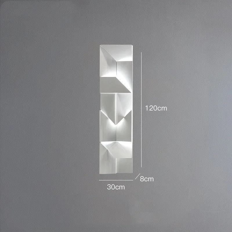 Minimalist rectangular wall lamp in matte white finish, shown in a living room setting.