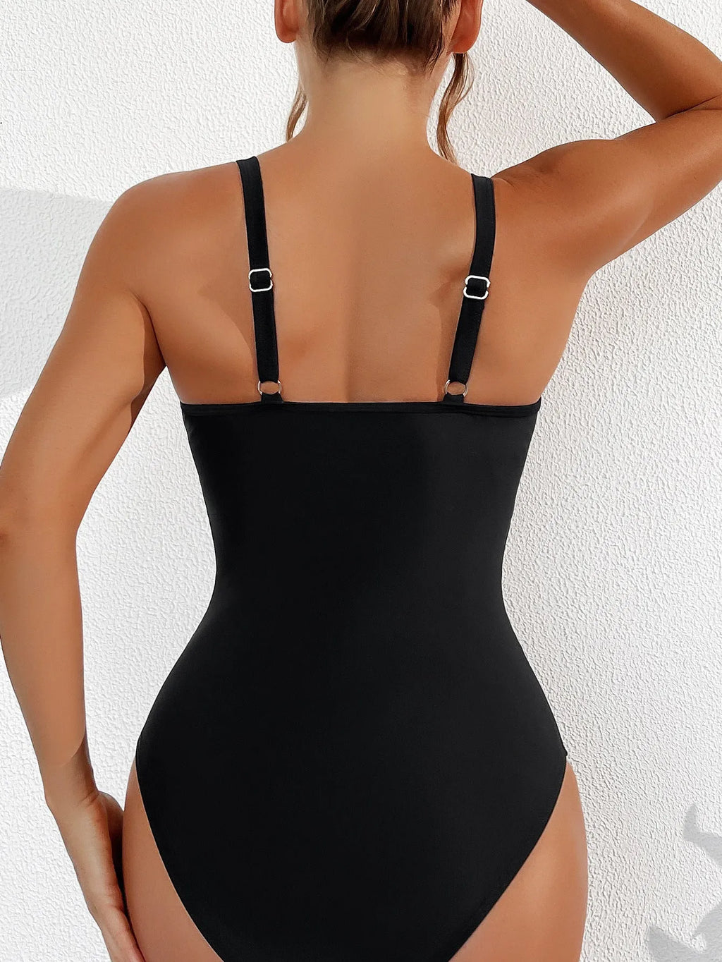 Black women's halter-neck one-piece swimsuit with mesh colour-block panels on mannequin.