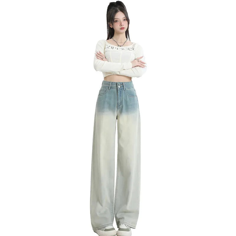 Women's gradient blue wide-leg denim trousers on a neutral background.