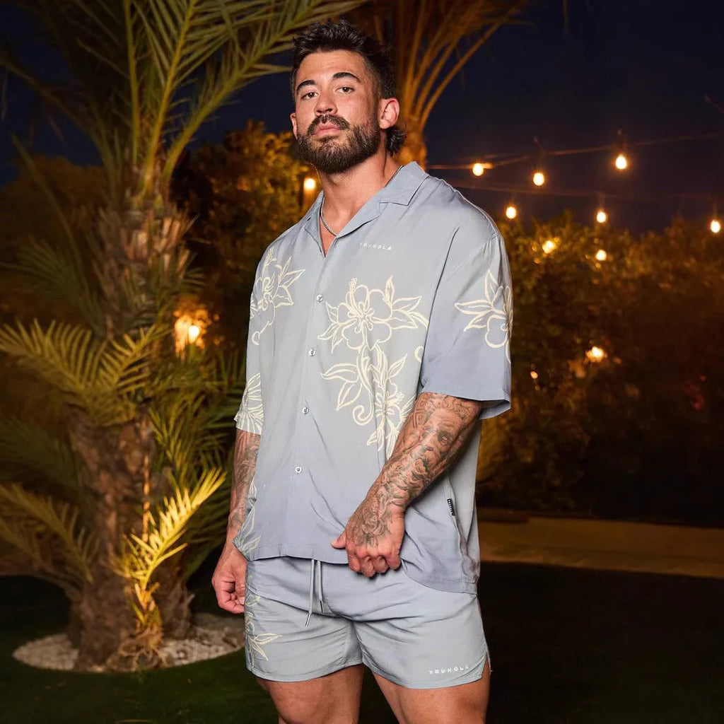 Men's loose-fit short-sleeve top with floral print in a light colour, shown on a hanger.