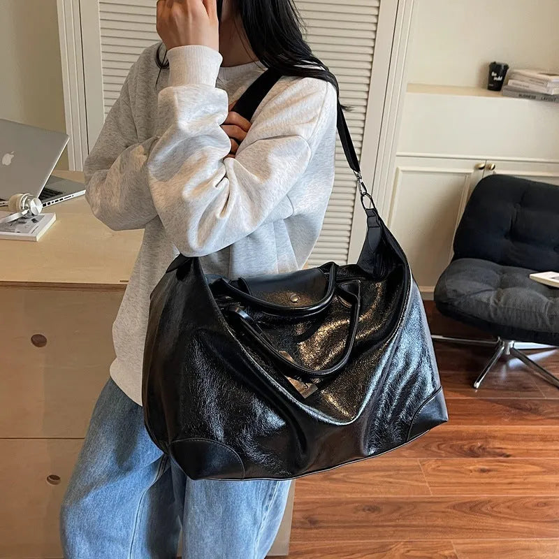 Black women's hand-carry travel bag with 36-55 litre capacity for short trips