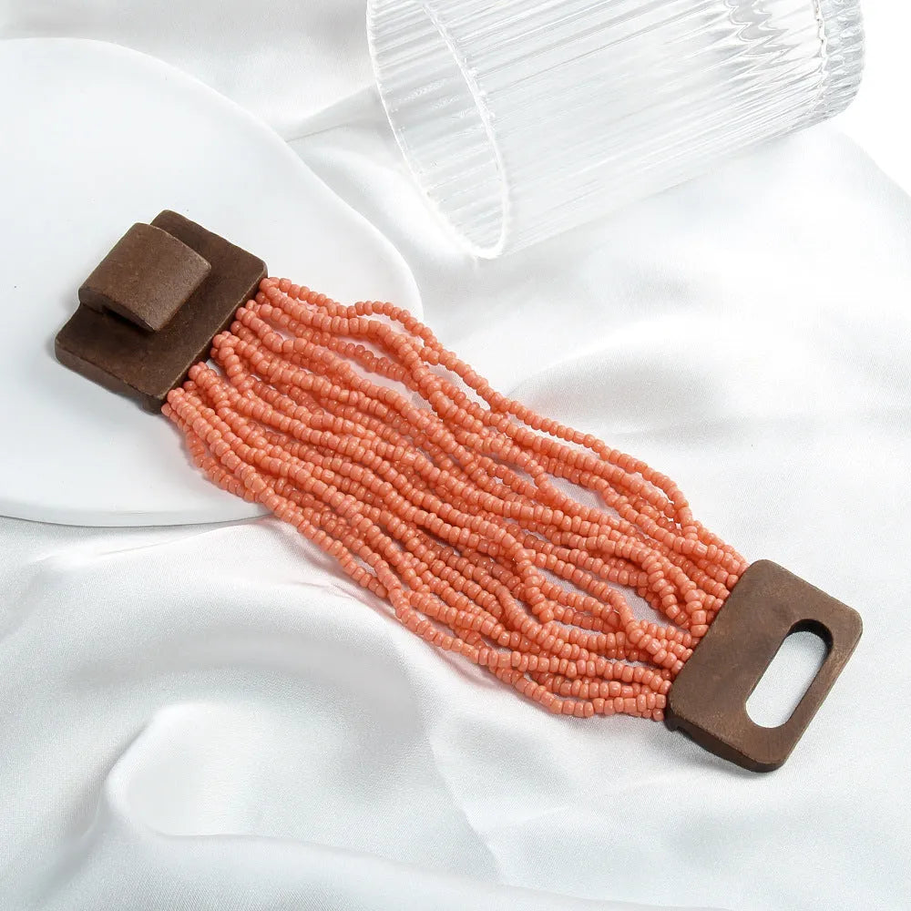 Handmade multi-layer elastic bracelet with rice-shaped glass and coloured glaze beads in geometric quadrilateral pattern, six colour options